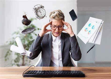 A small business owner looking overwhelmed or stressed while juggling multiple tasks